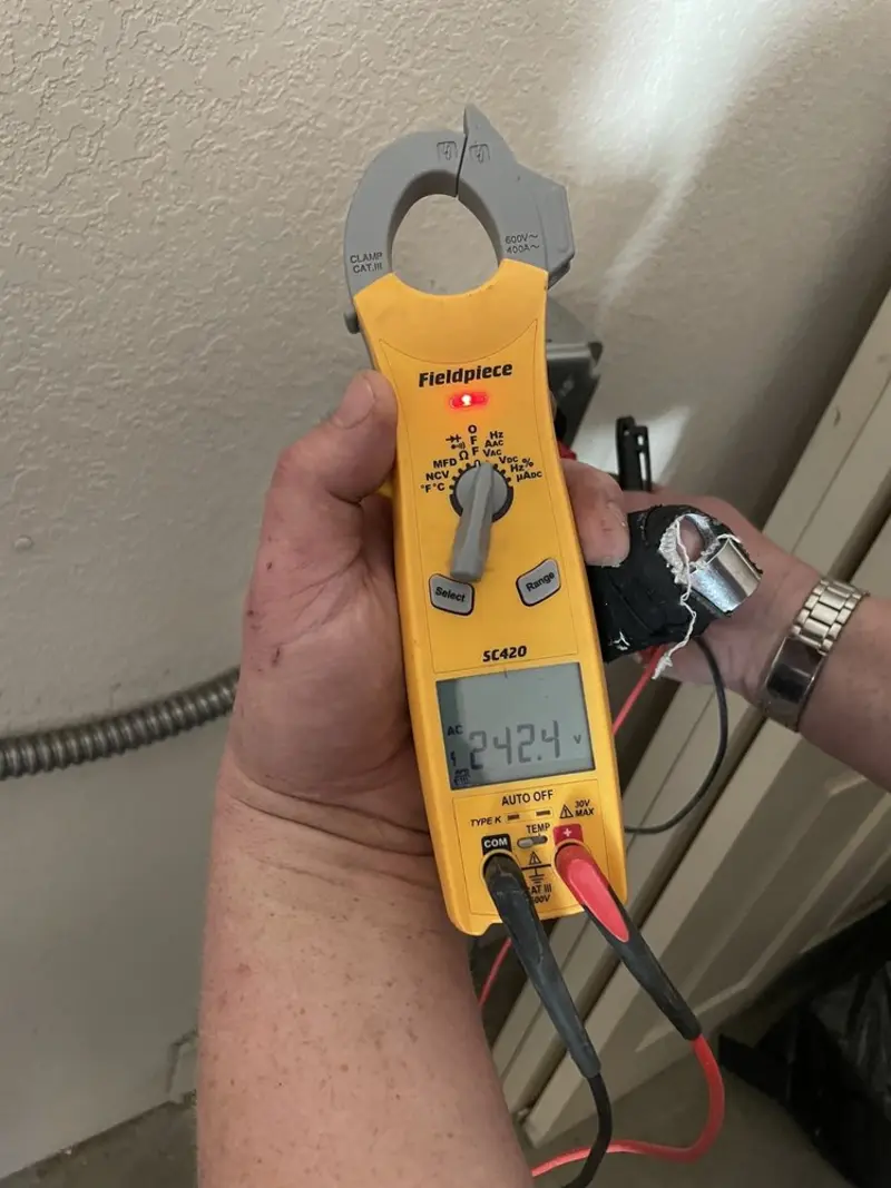 Voltage testing with clamp meter during Electrical Installation Services in Albia